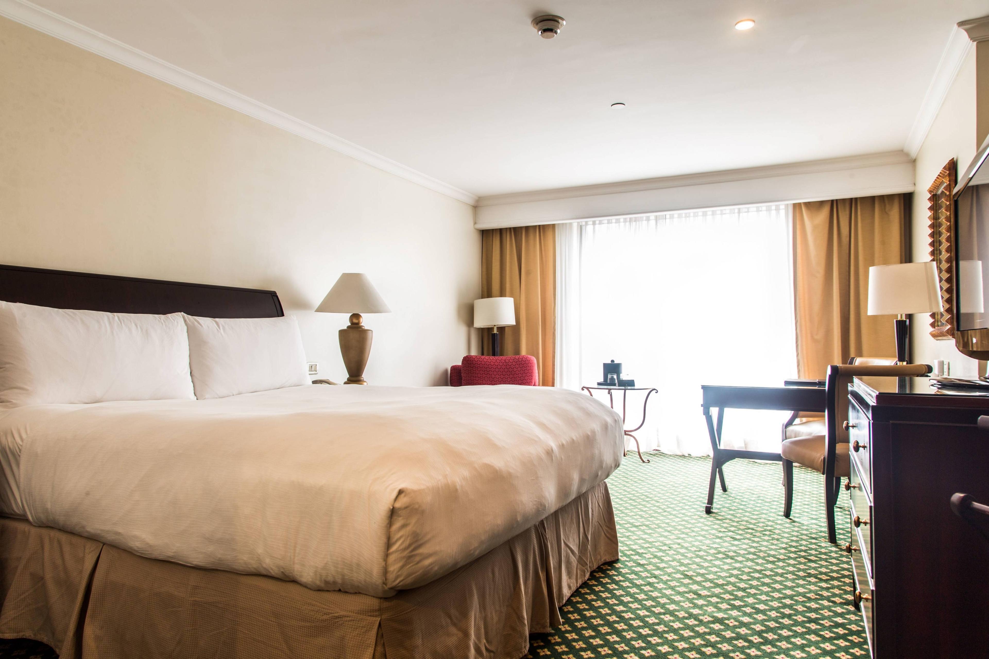 Our guest rooms feature elegant, dark wood furnishings in a comfortable setting, high-speed Internet access, luxury bedding, and a work desk with ambient natural daylight.