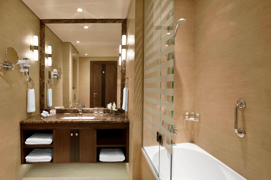 With soft and neutral material choices and luxury touches, our guests will love the smart storage solutions and the simple vanity design of this beautiful and spacious bathroom.