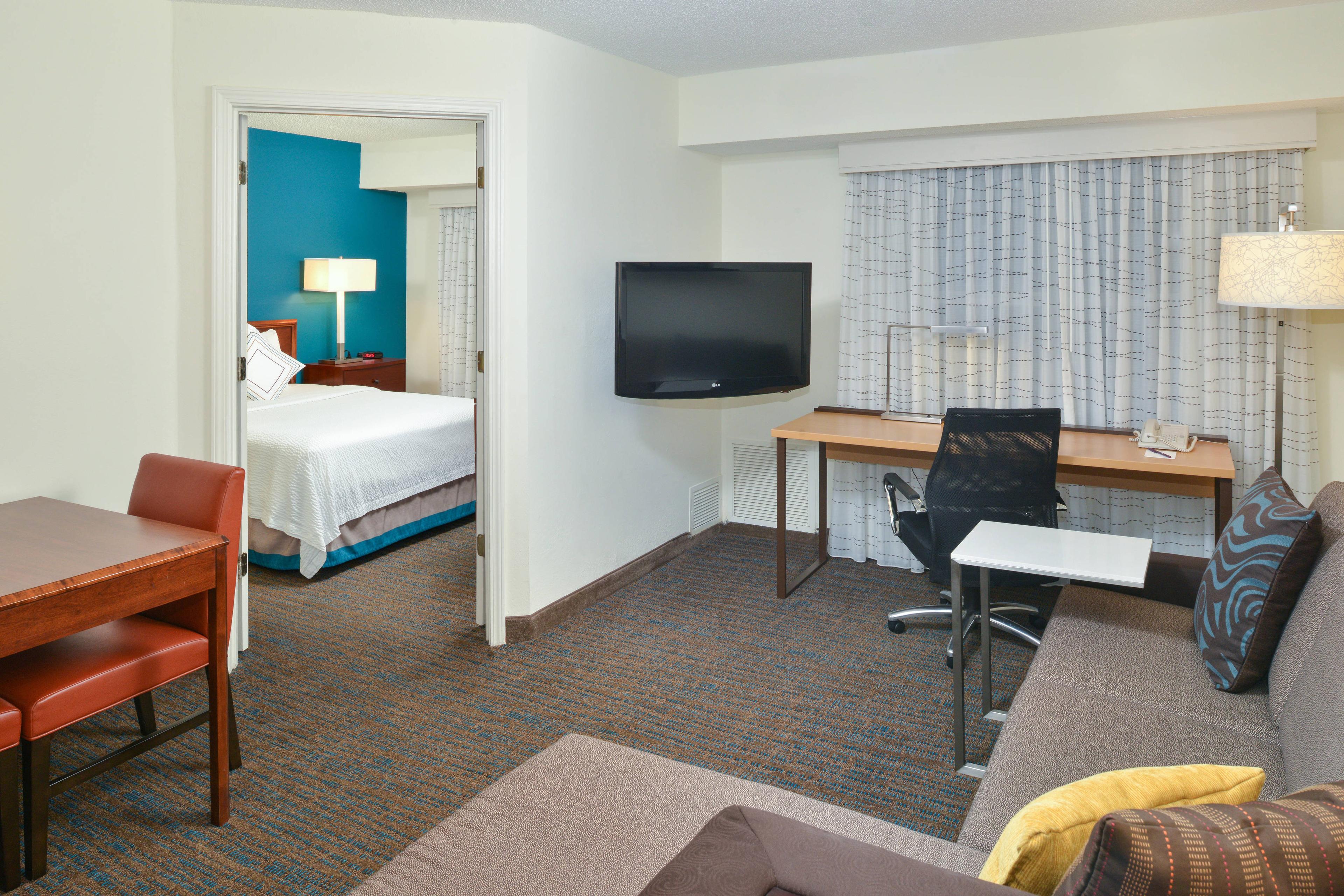 Enjoy the extra space and privacy of a separate bedroom with queen bed in our One-Bedroom Suites.