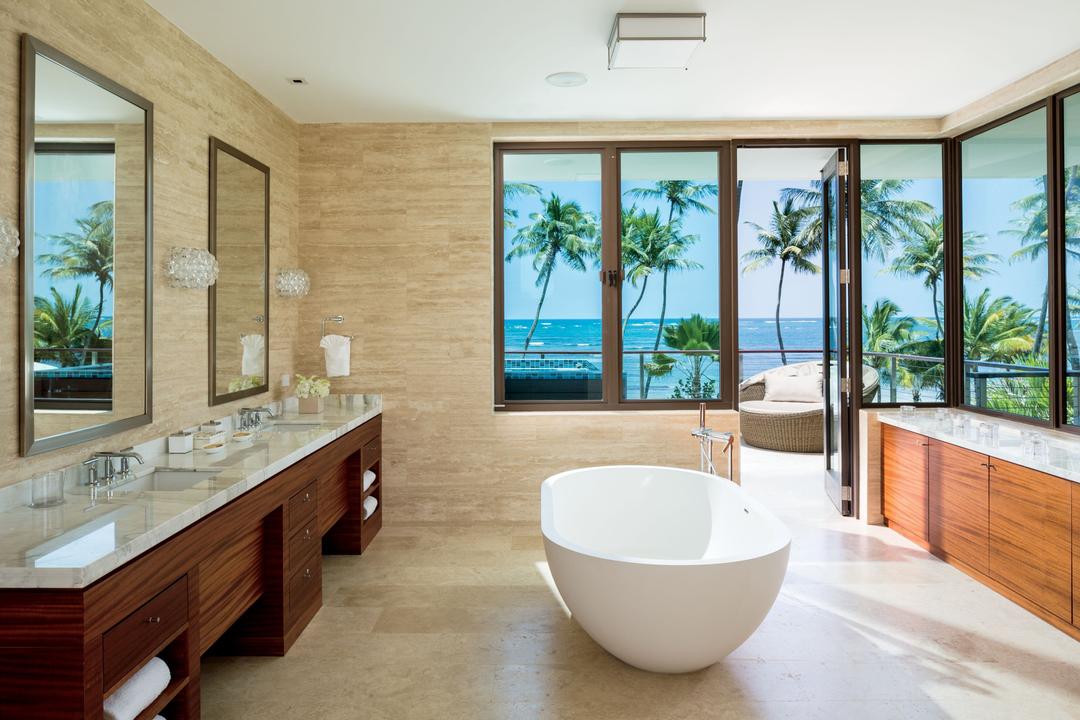 The master bathroom offers a spacious room with sweeping views of the ocean.