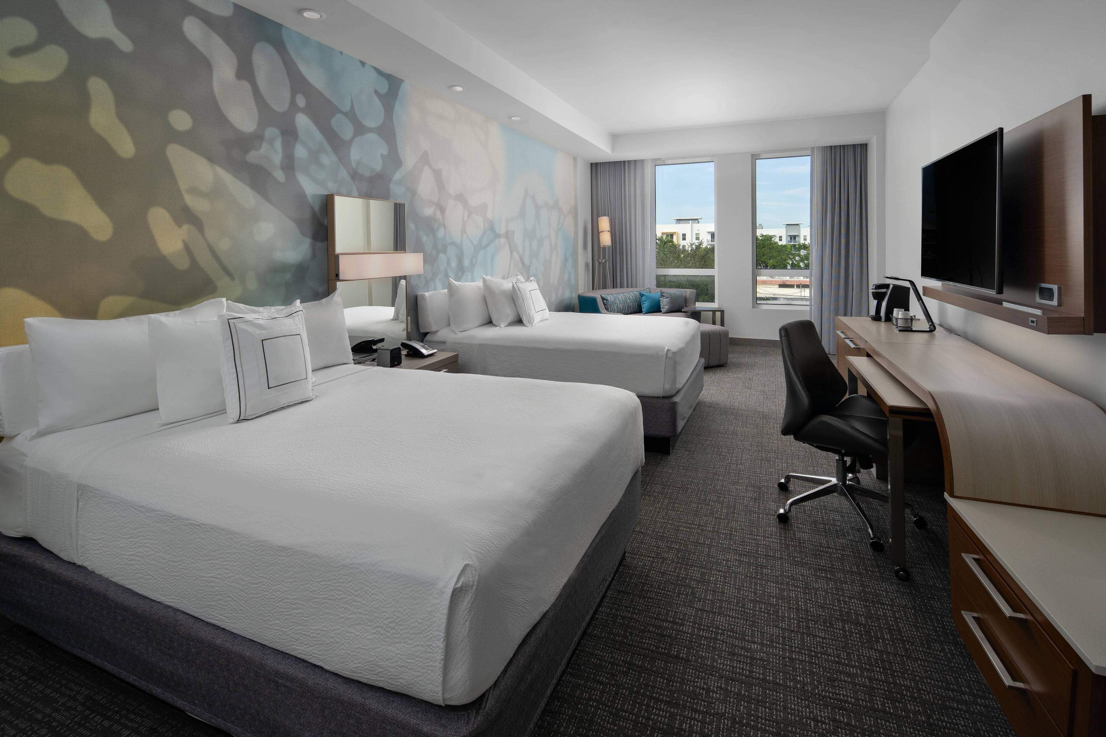 ad out in our spacious queen/queen hotel rooms in Delray Beach, Florida, featuring modern decor, plush beds, ergonomic workstations, flat-screen TVs and complimentary high-speed Wi-Fi.