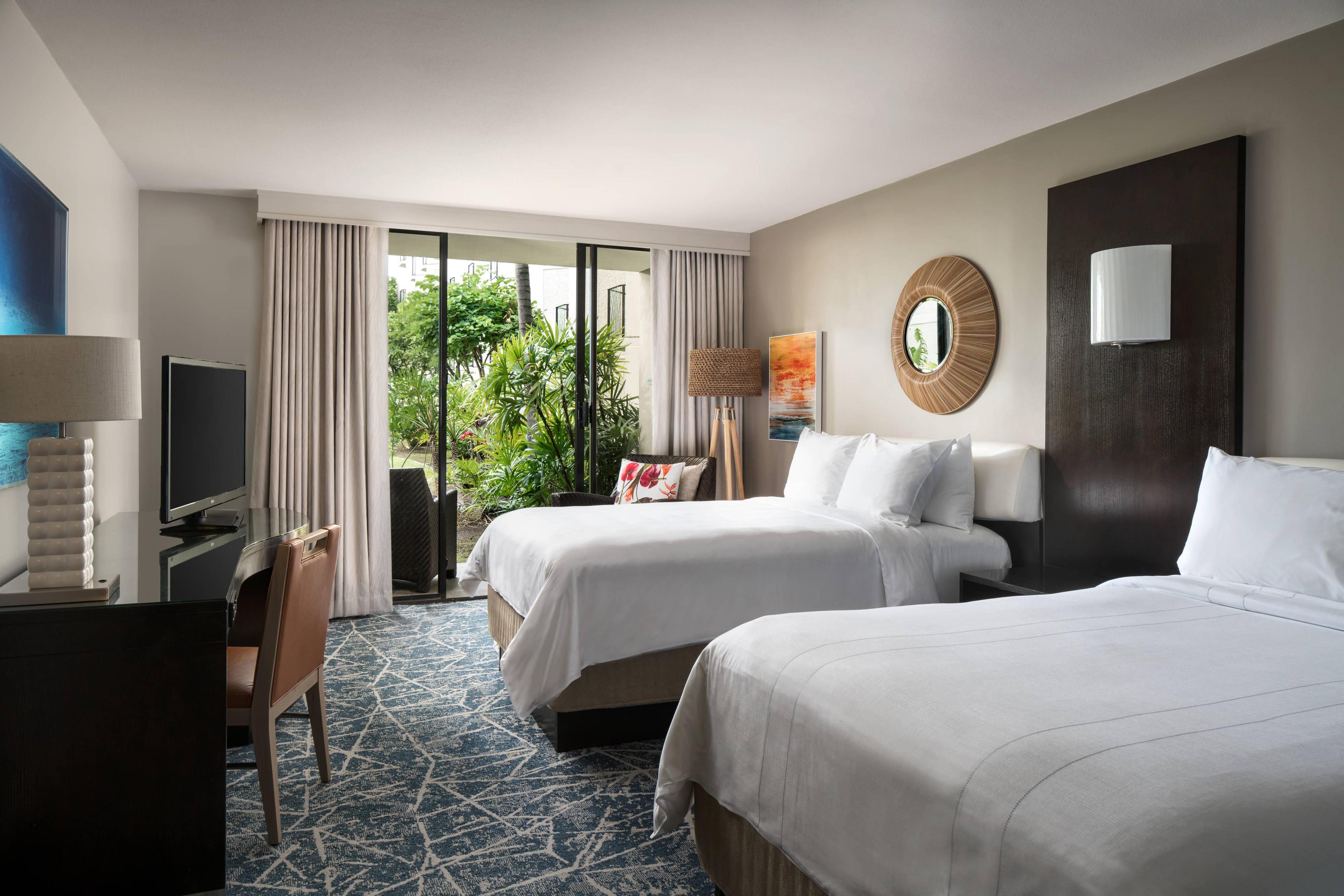 Our Garden View Guest Room offers two double beds and a patio for relaxing or entertaining.