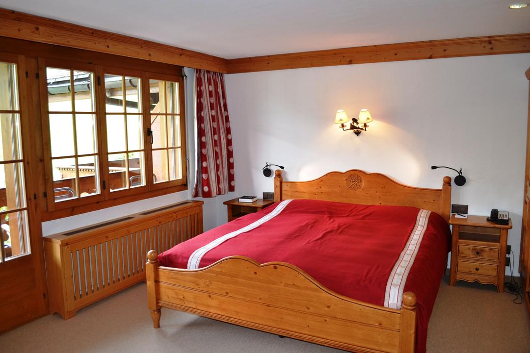 Cosy double rooms in typical Swiss chalet style with balcony East side view of the surrounding mountains. Bathroom with shower.