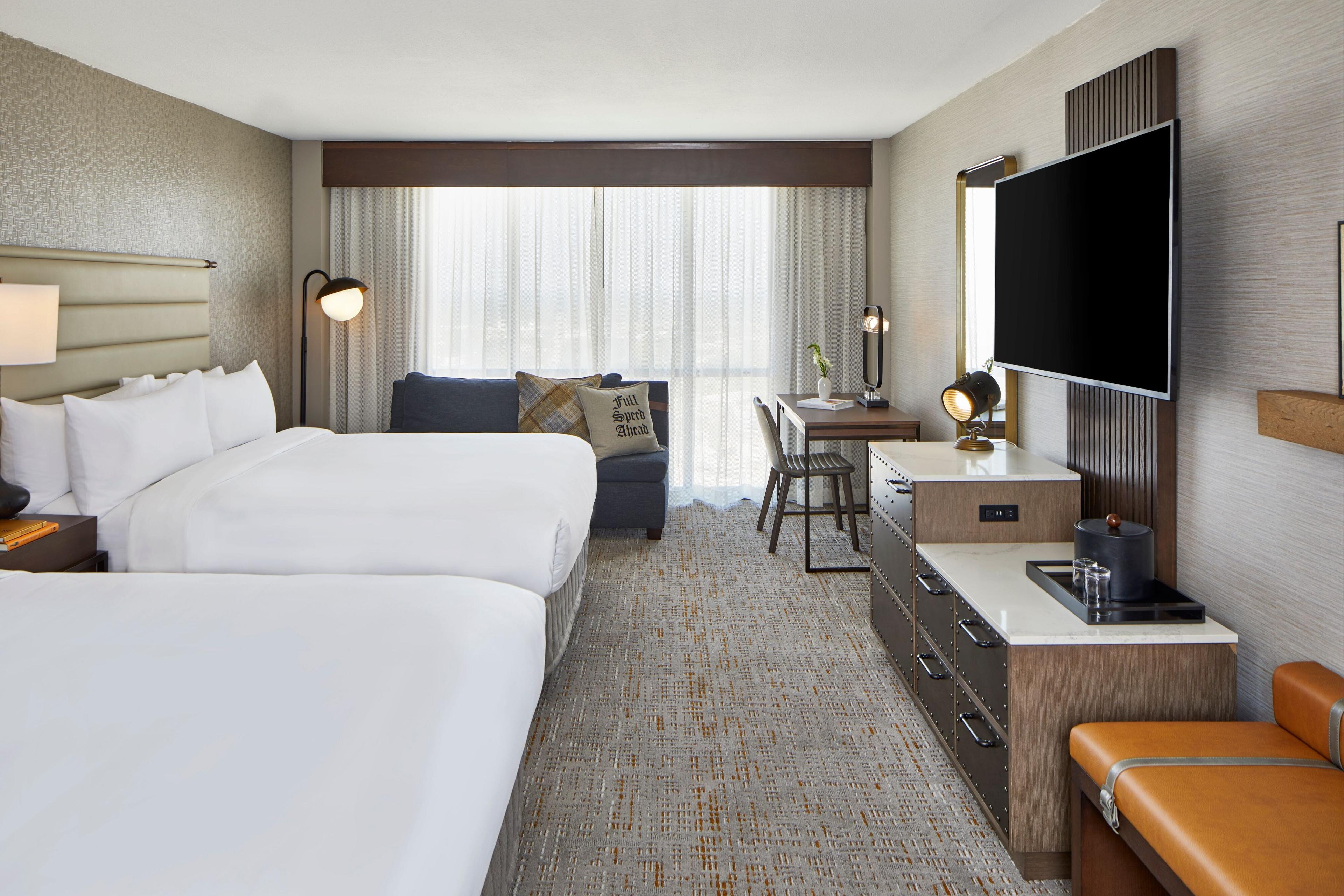 Our guest rooms with two queen beds offer flat-panel TVs with premium cable and movie channels, work desks and connectivity panels for your electronics.