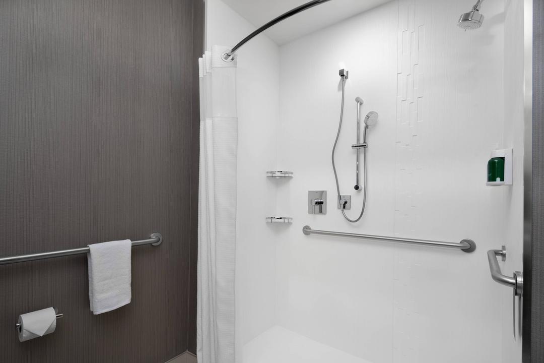 Our ADA compliant shower features thoughtfully placed bars and amenities, making it safe and easy for guests to access