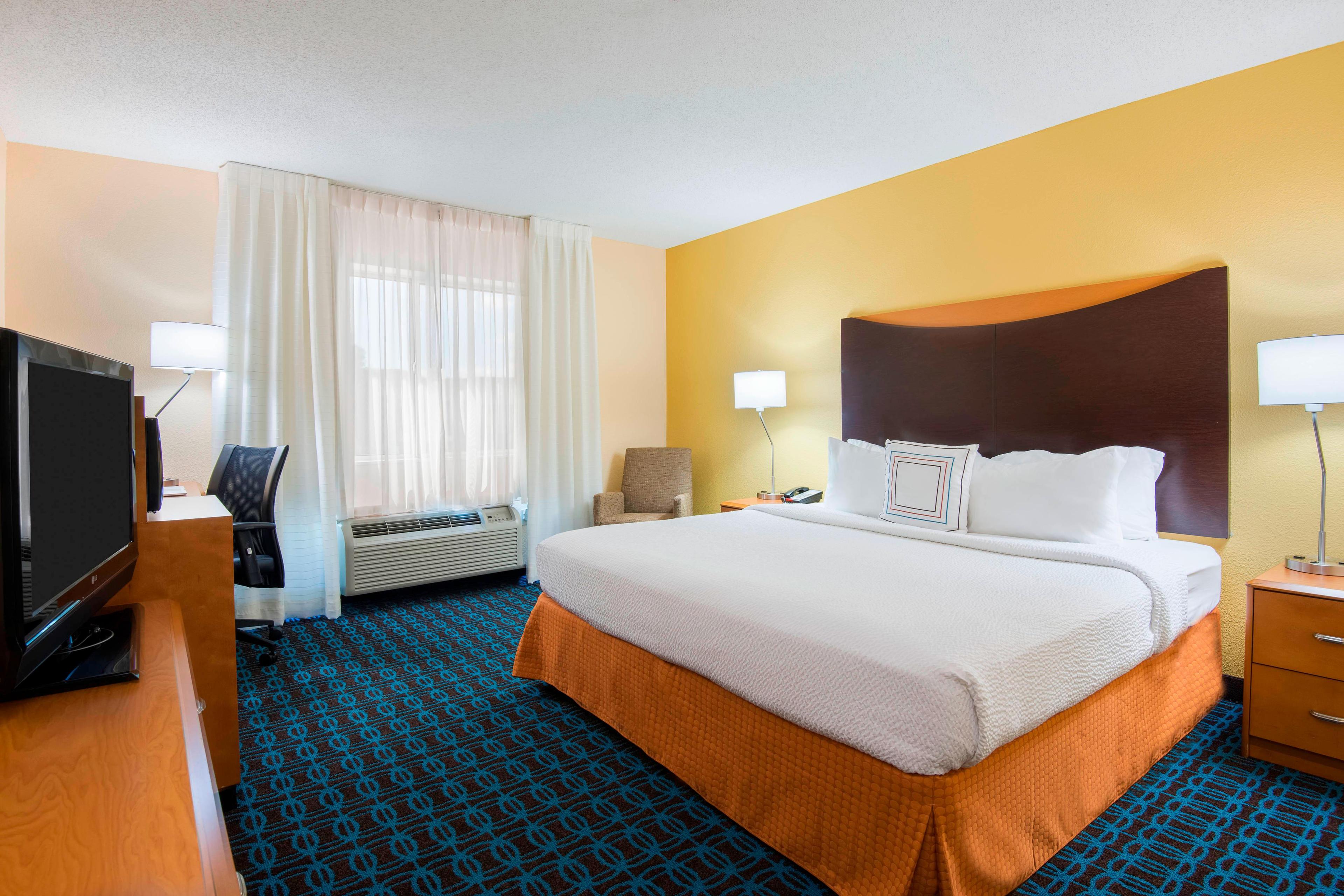 Kick off your shoes in our comfortable king guest room, with plenty of space to relax and stay productive featuring a well-lit large desk with convenient outlets and an ergonomic chair for comfort, an in-room coffeemaker, coffee and iron and ironing board.