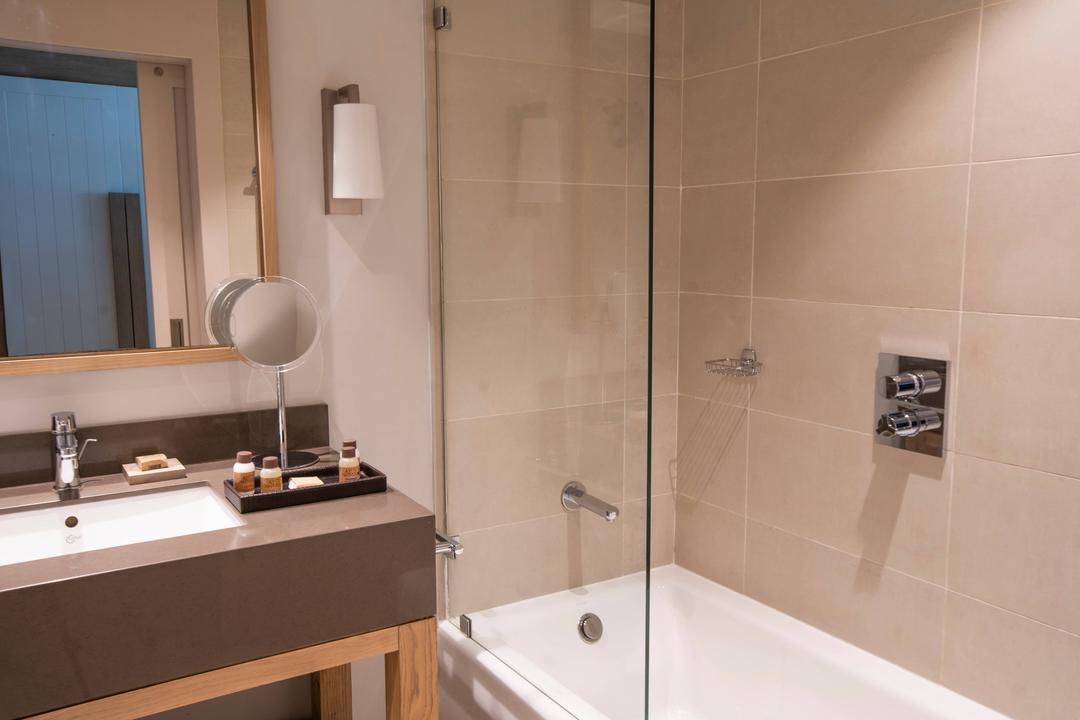 Our bathrooms feature bathtub, large vanity mirror and high end amenities