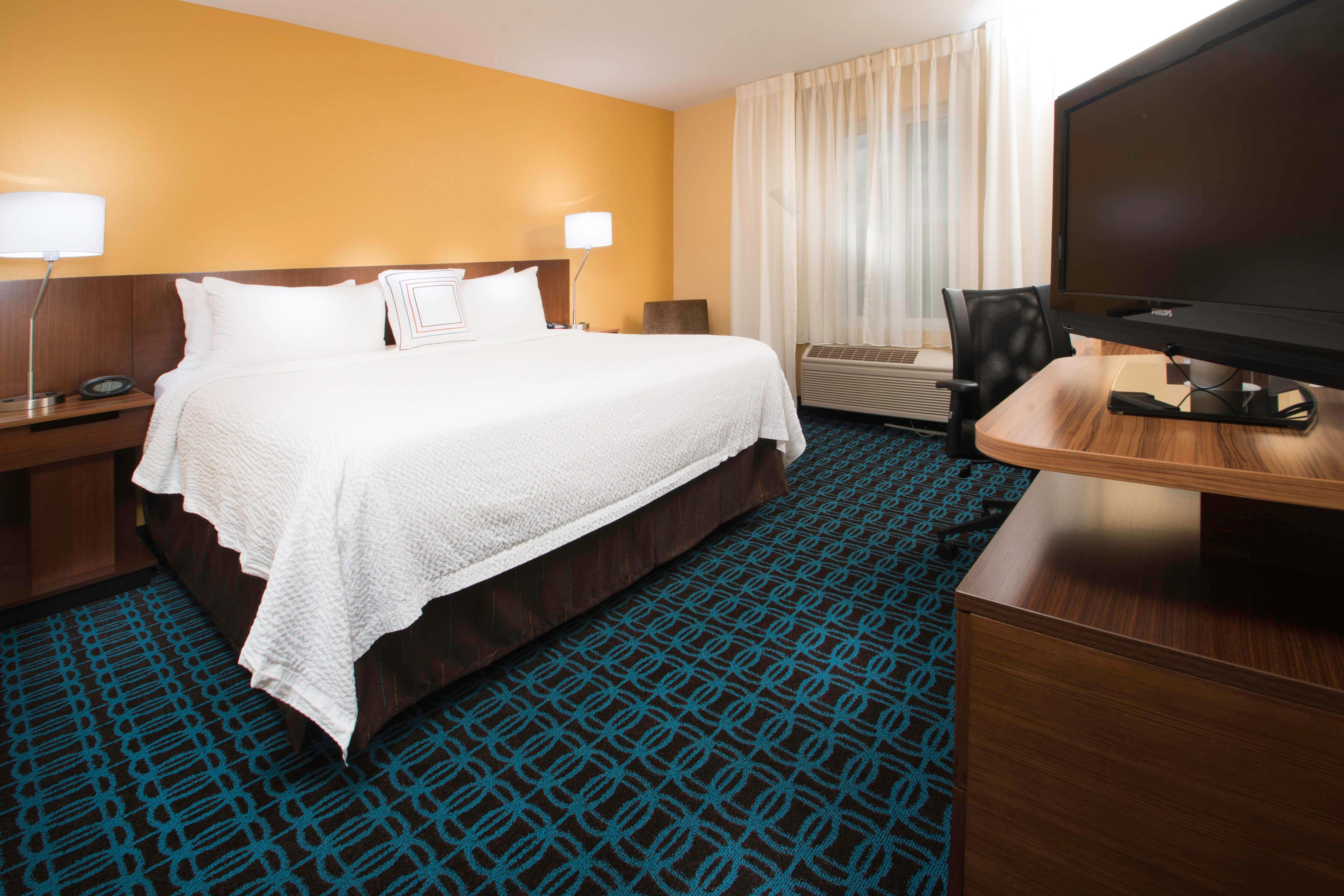 Our king guest room with fresh clean linen, work desk, 42-inch television, refrigerator and microwave.