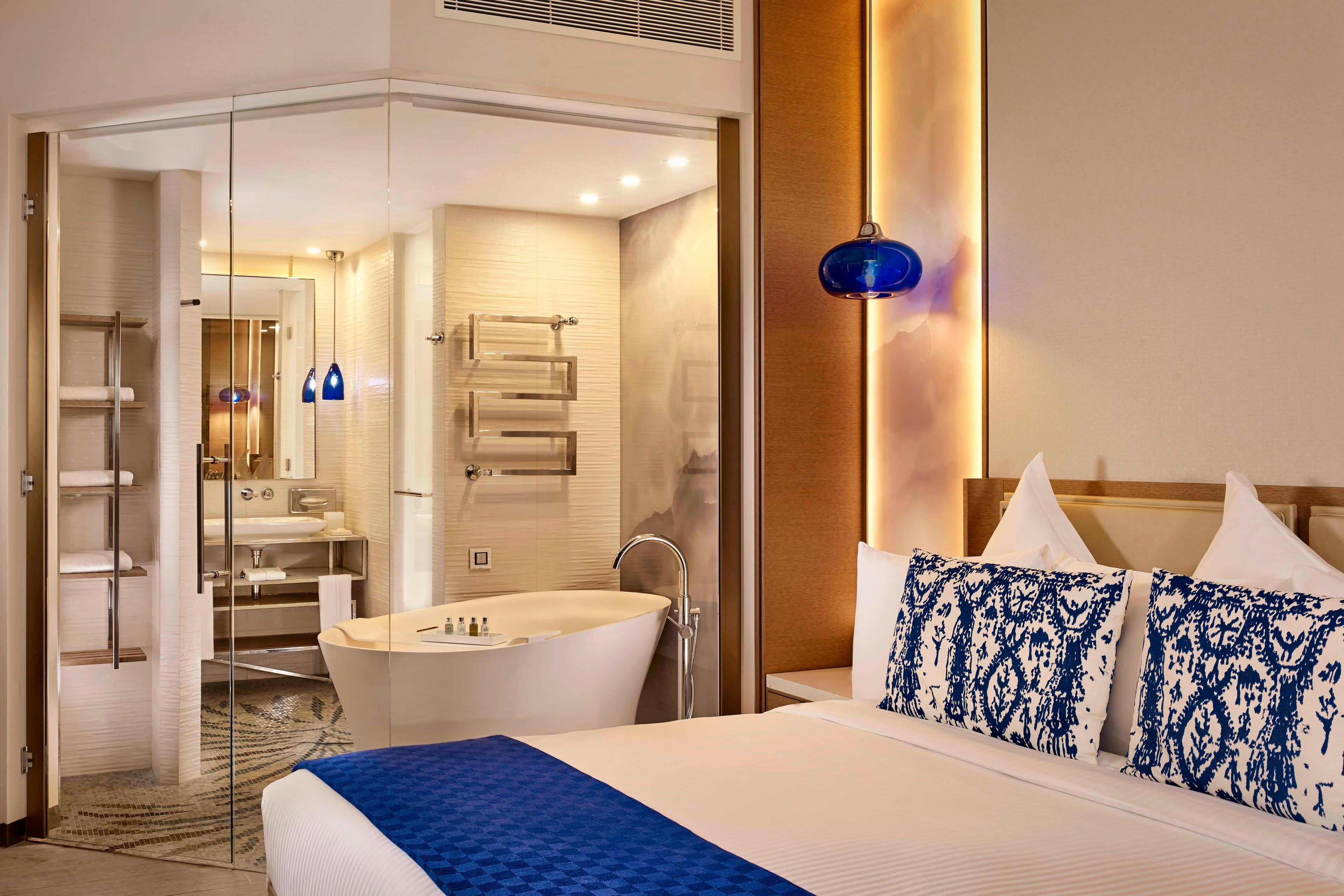 Stunning architecture and thoughtful design allow you to enjoy every aspect of your suite. The Deluxe King room includes a glass-walled bathroom with rainfall shower and mosaic detailing.