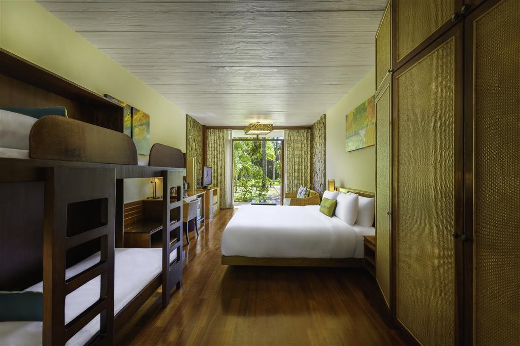 Interior view of Avani Family Room bedroom with king bed and bunk beds