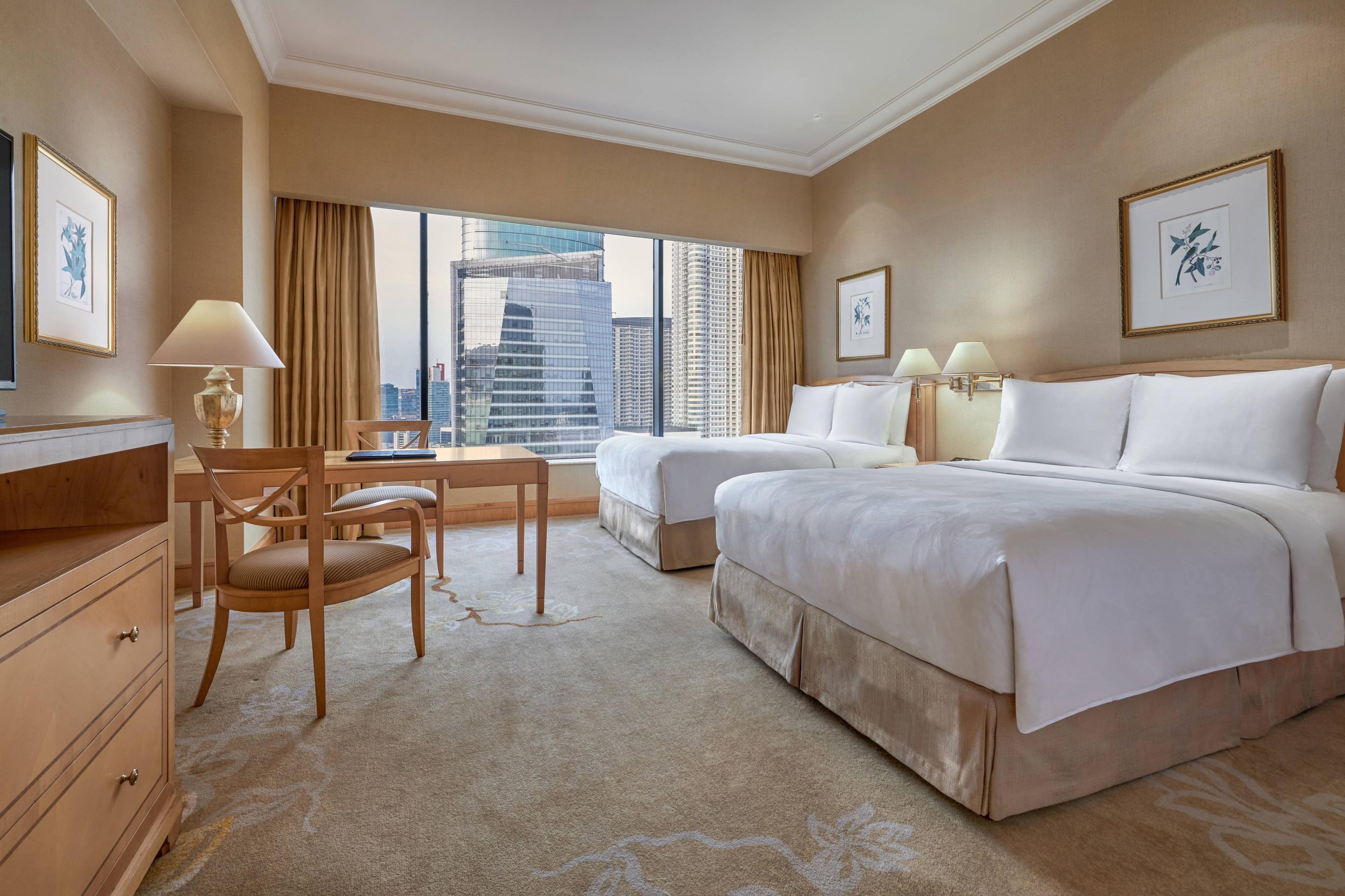 Our comfortable Deluxe Guest Rooms feature two twin beds and beautiful city views.