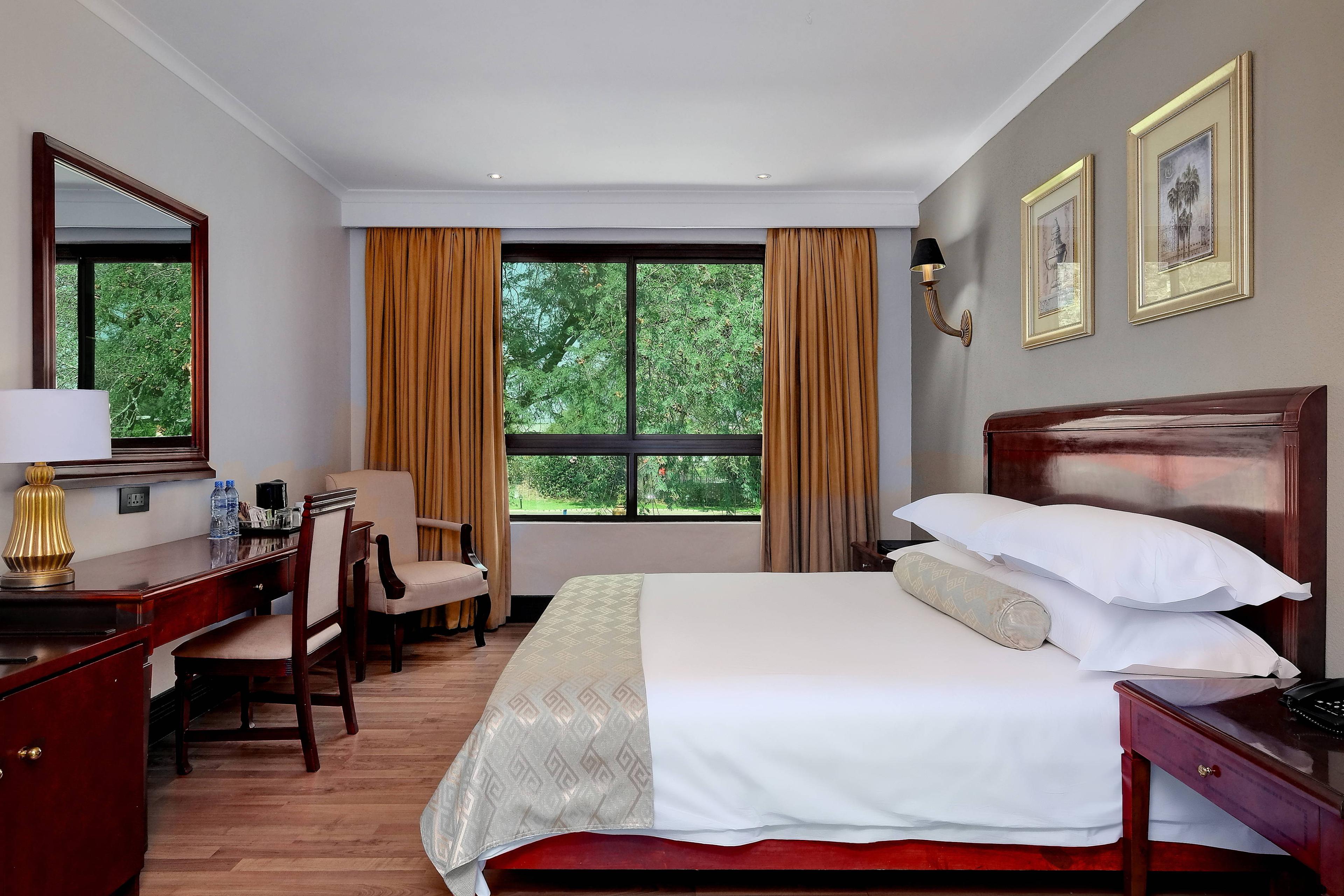 Wake up refreshed and ready to start the day in Livingstone in our deluxe king guest room with a stunning view of the lush property.