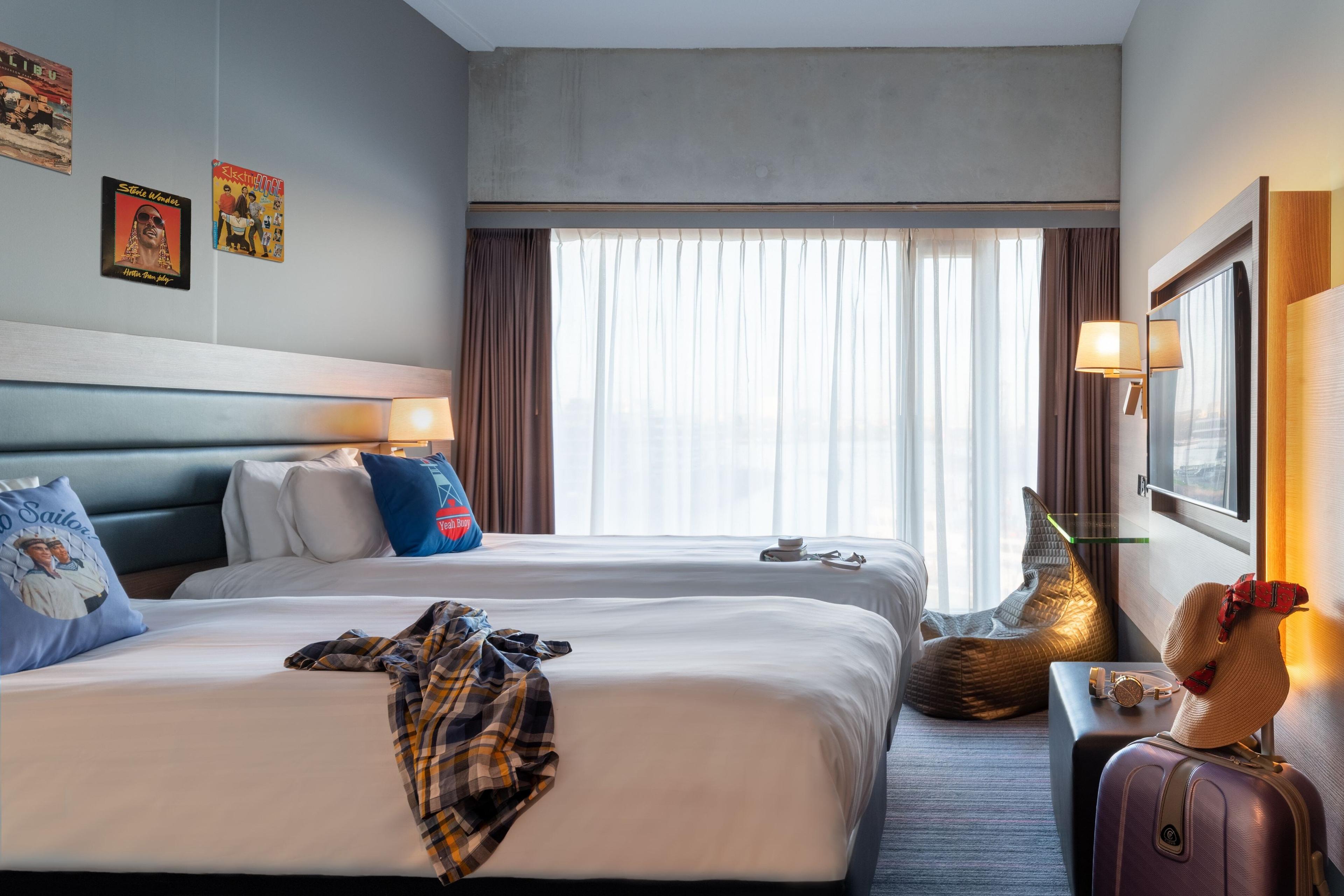 Our industrial-chic Moxy Sleeper Twin rooms are perfect for comfortable sharing thanks to two separate beds.