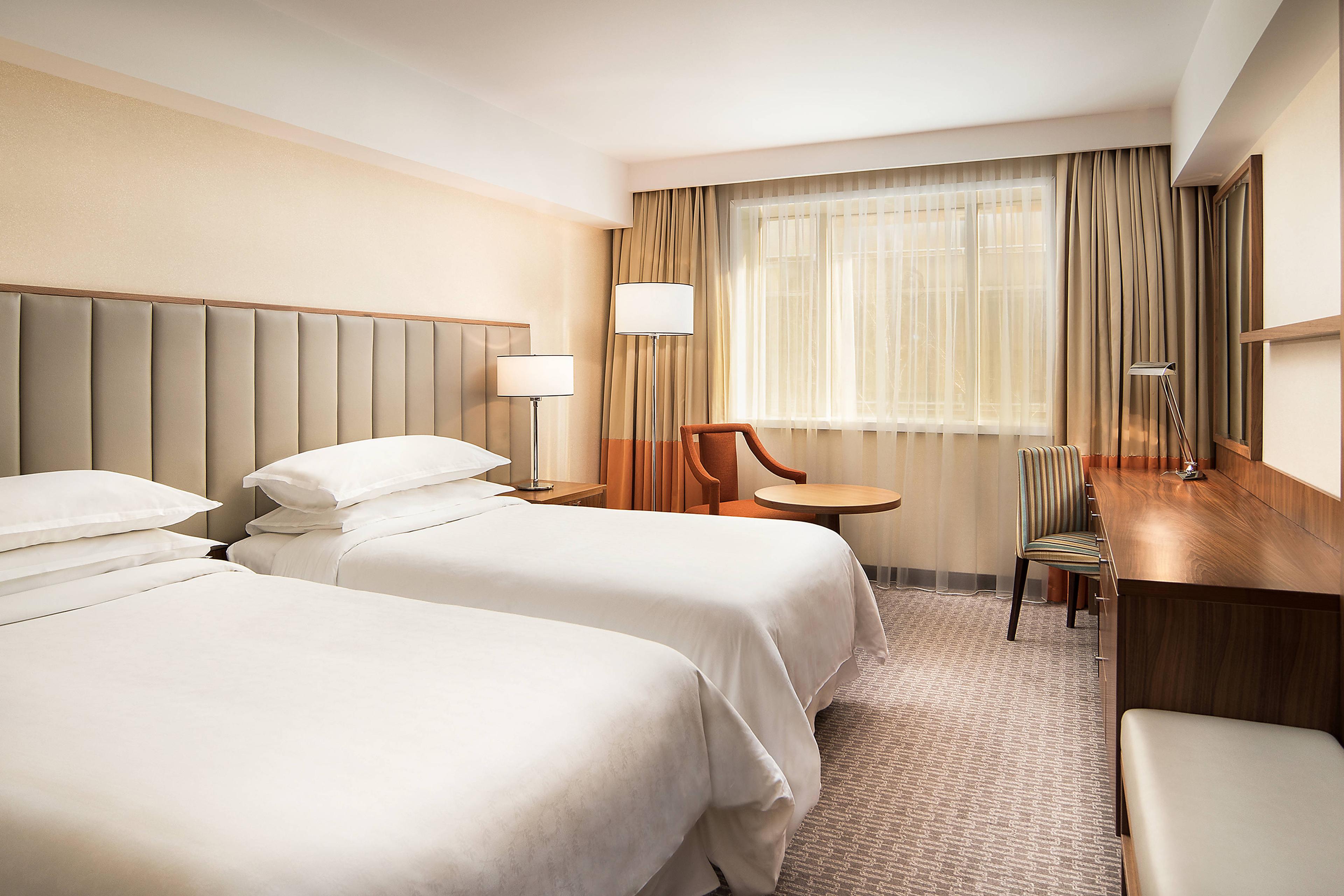 Enjoy the spacious accommodations in our Deluxe rooms, featuring twin beds.