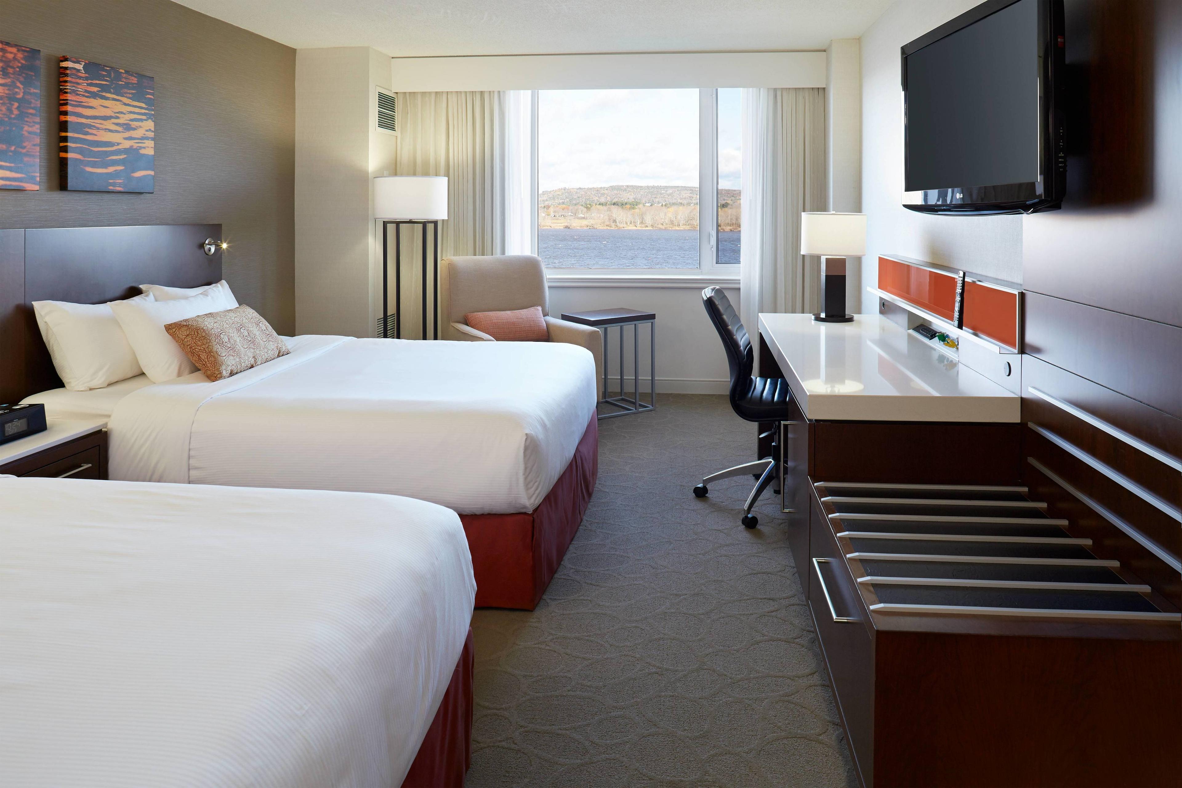 Our spacious and comfortable guest rooms feature sanctuary bedding, a flat-panel TV, a SmartDesk™ with multiple connectivity docks, complimentary wireless and wired high speed internet access, and spectacular views of the Saint John River.