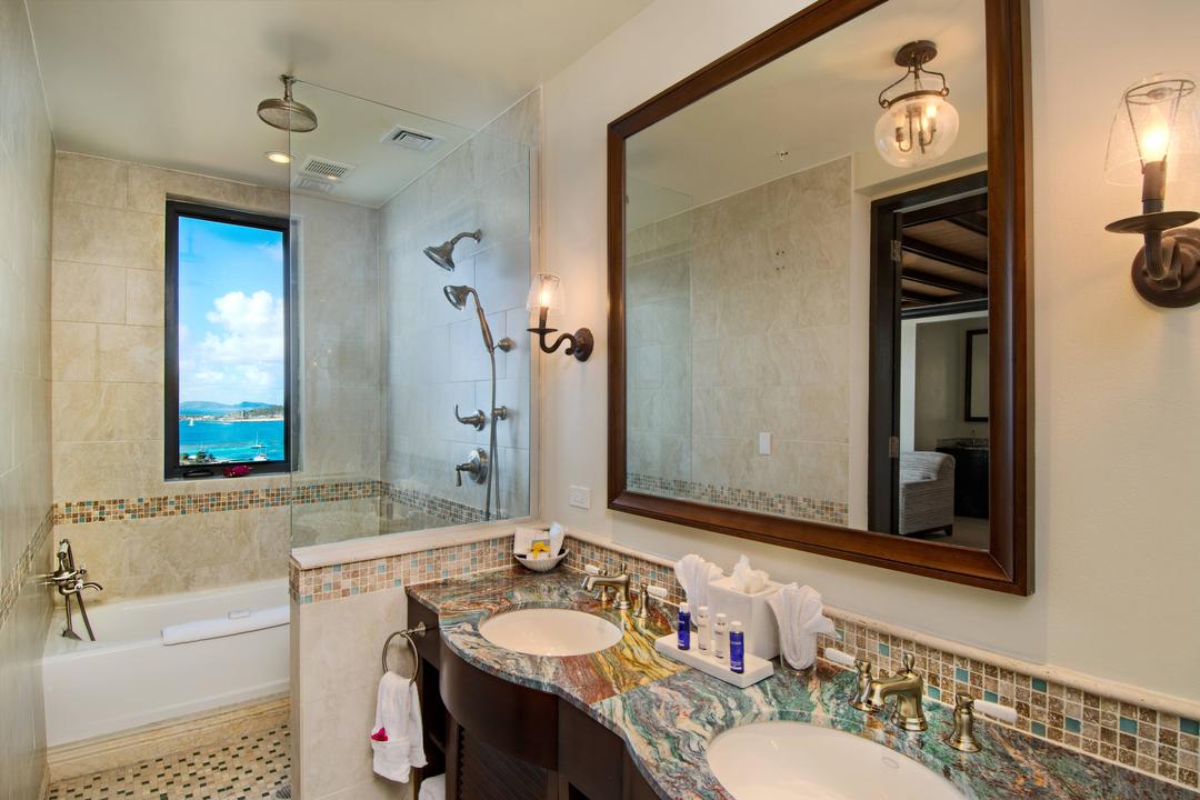 Well-appointed bathrooms feature luxurious bath amenities and picturesque views.