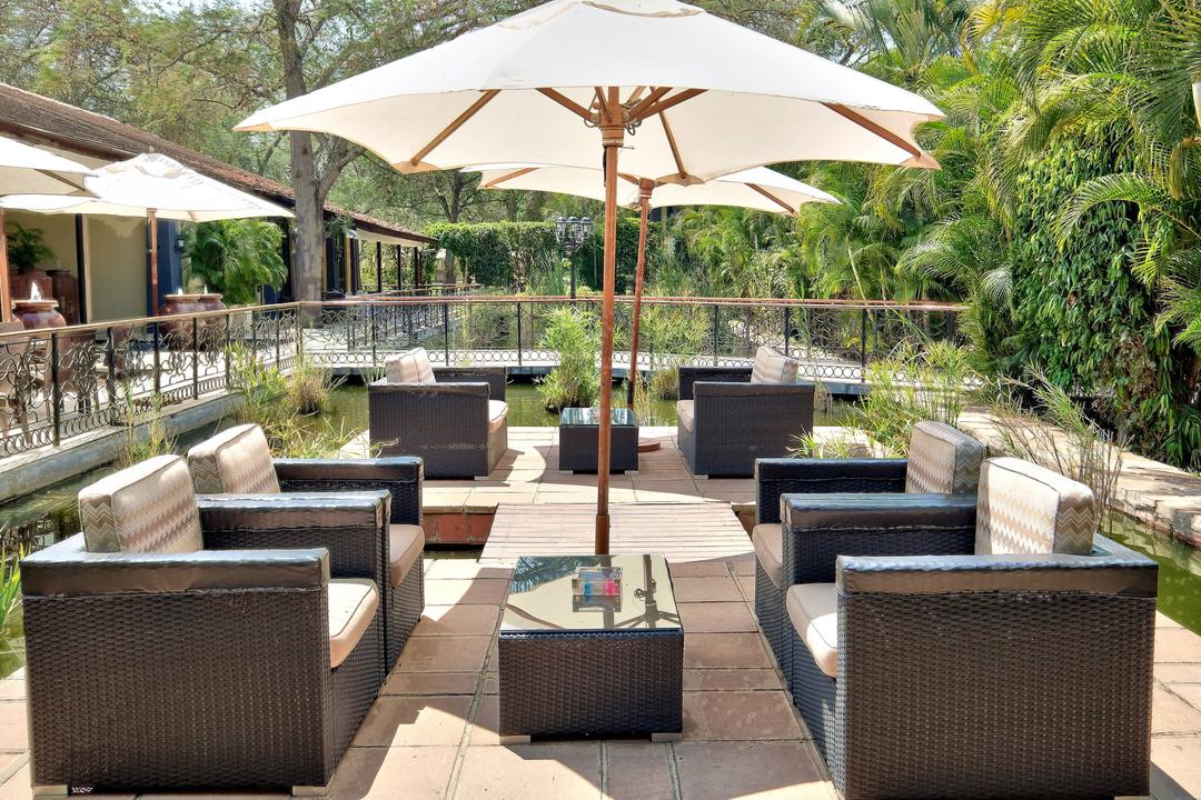 Sit outside and relax while enjoying the fresh breeze surrounded by lush greenery on our hotel's terrace.