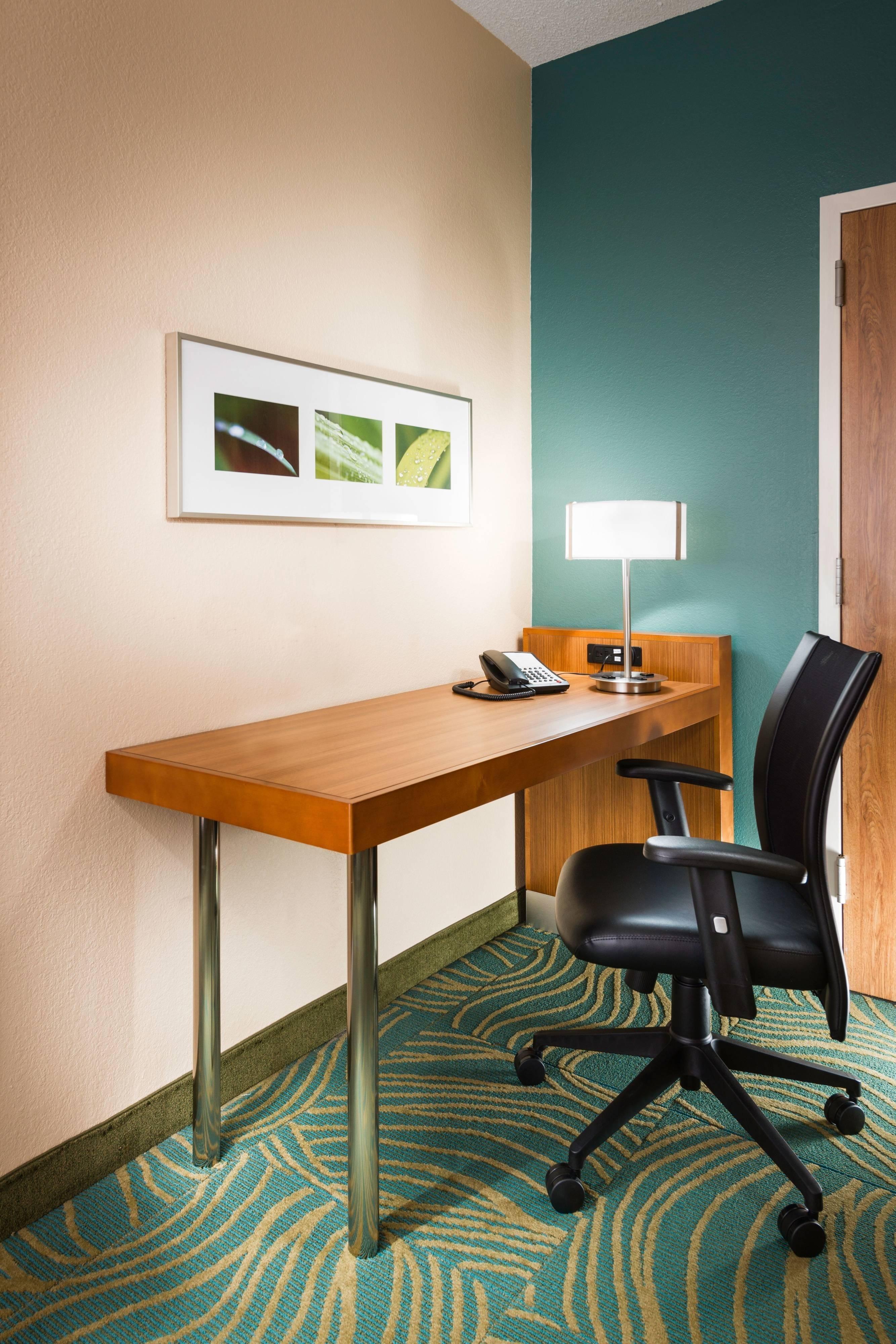 Our guest rooms offer a new desk area great for catching up on work projects.