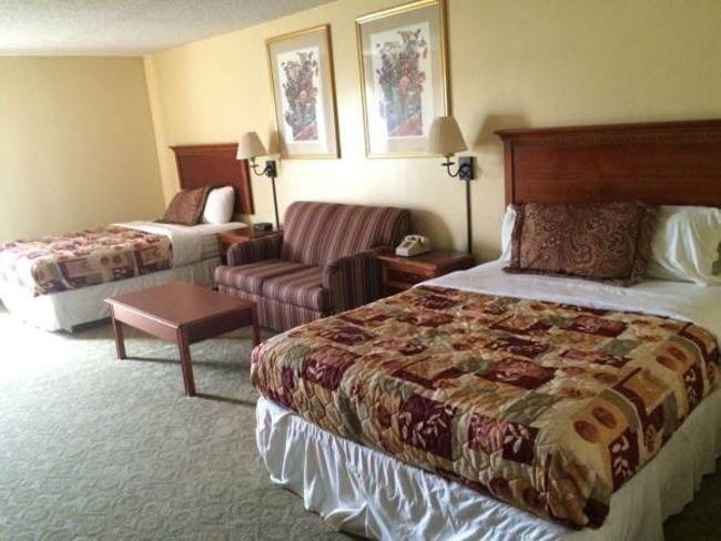 Two Queen Beds and Couch. Free wi-fi, telephone, cable/satellite TV, bathroom with tub/shower, toilet, hairdryer, mirror. Work table with chairs, Microwave, refrigerator, coffee/tea maker.