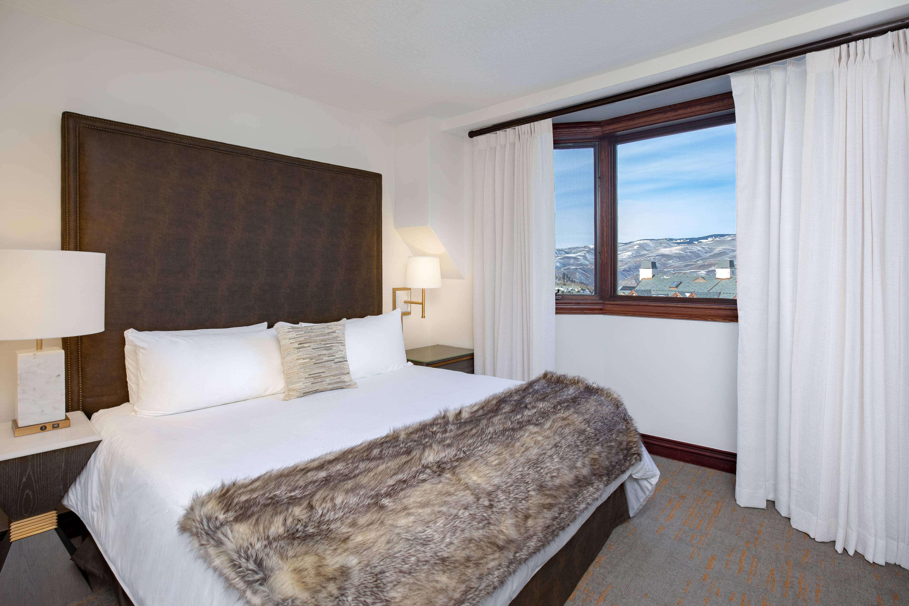 From your large suite with a king-size bed, experience spectacular resort views of the valley below while you lounge on plush bedding with your faux fur throw.