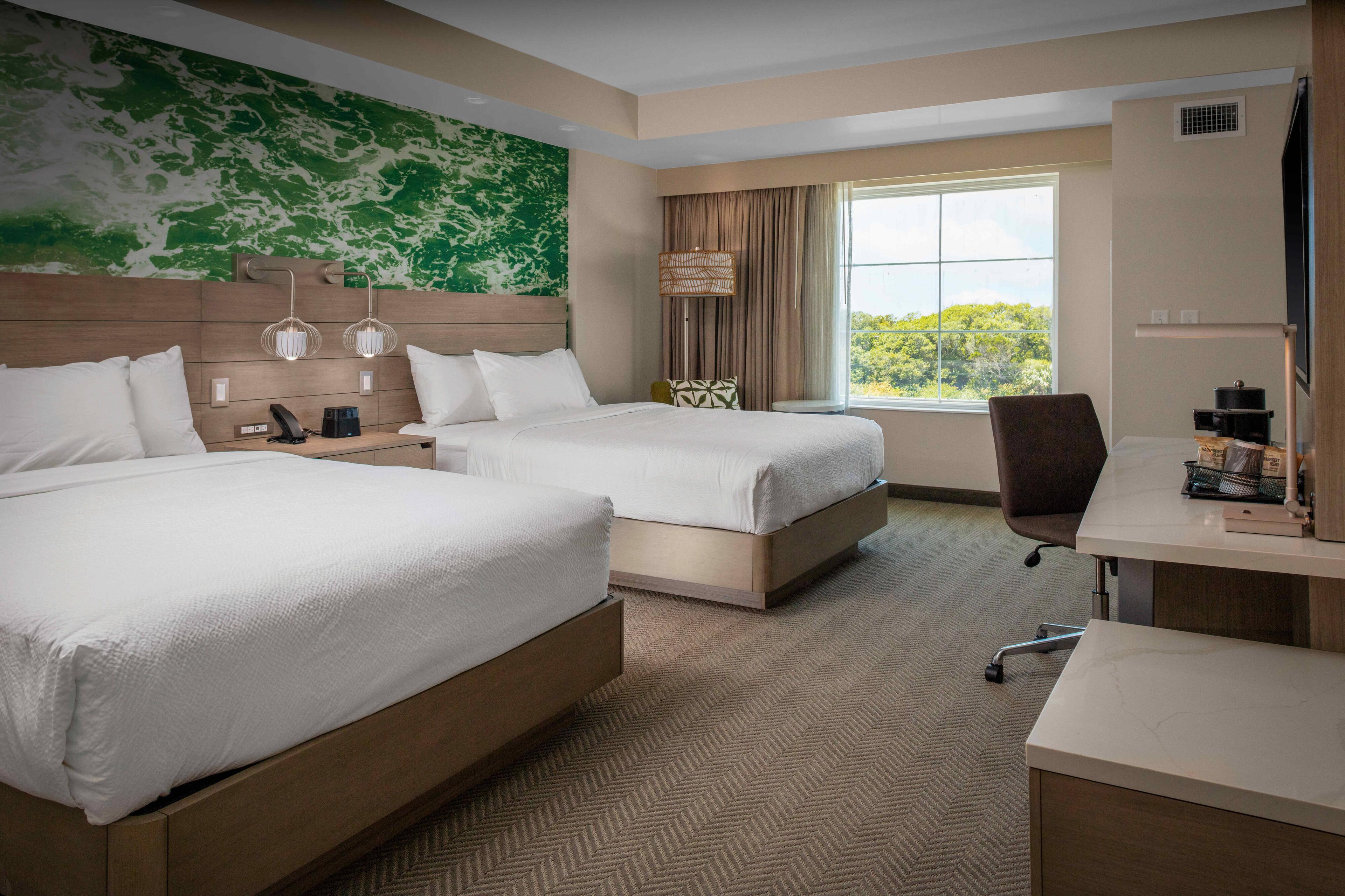 Experience luxurious comfort in our well appointed two queen guest room with desk and modern amenities.
