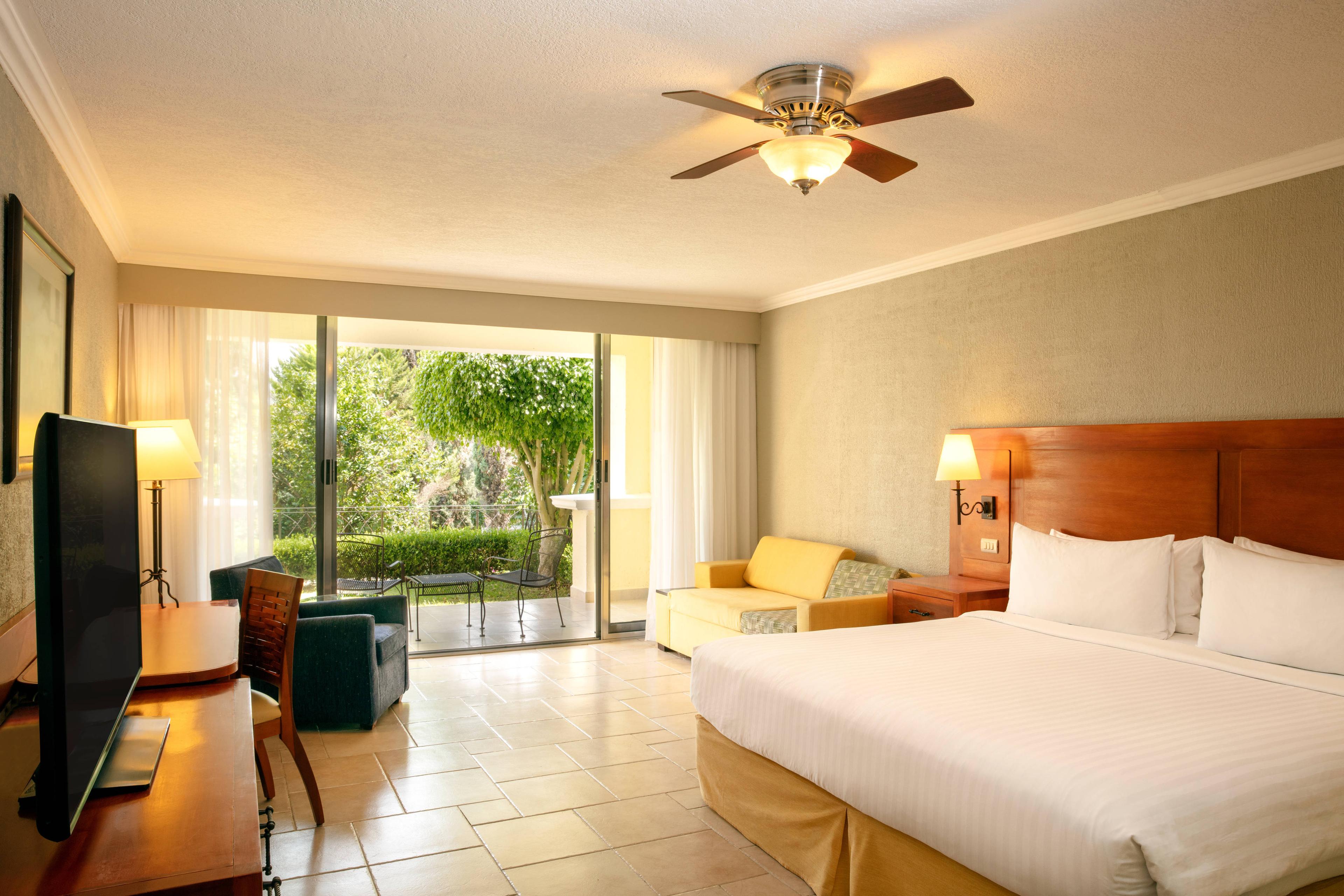 Our guest rooms with terrace views feature private patios to enjoy our hacienda-style resort's gardens.