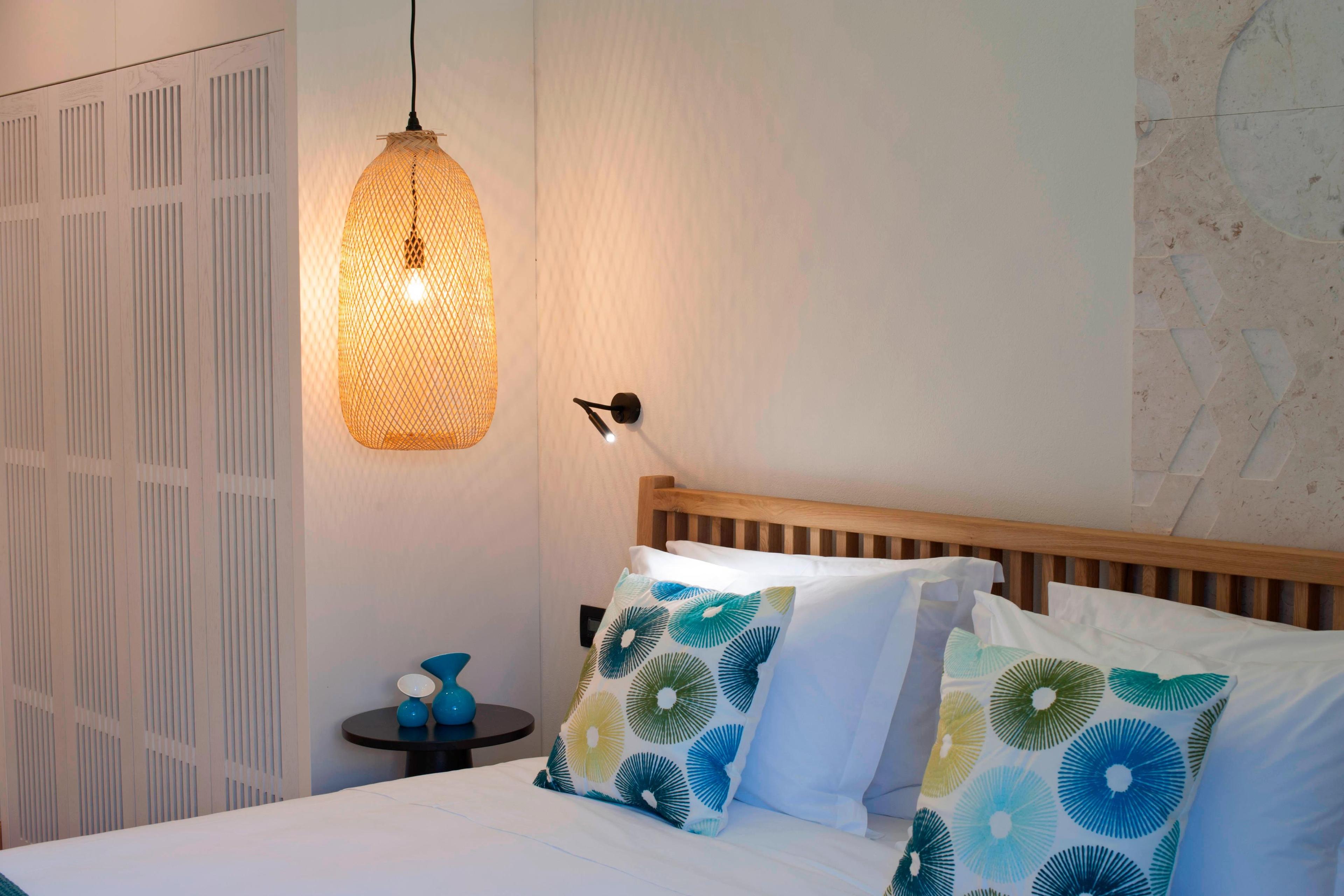 Light color hues dominate the upbeat retreat pool view guest bedroom.