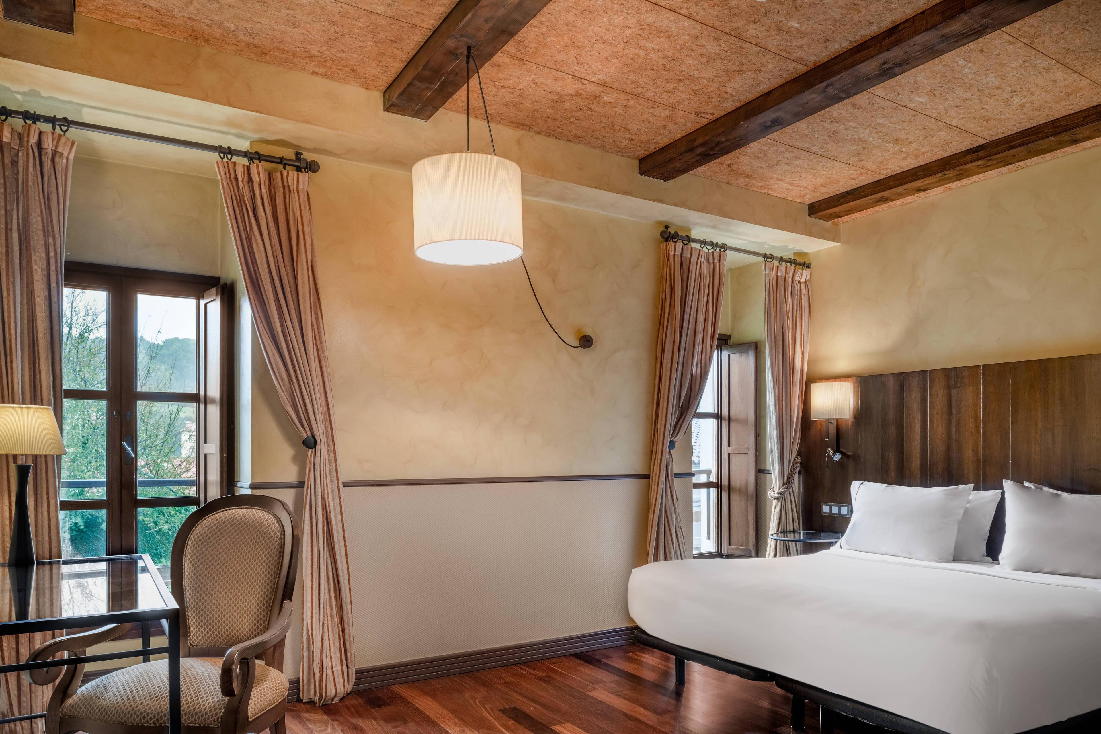 The King Deluxe Rooms of this former convent in Santiago de Compostela, feature a comfortable king size bed and several amenities and facilities to experience a prefect stay. All of them are decorated with the high quality furniture and with warm colors.