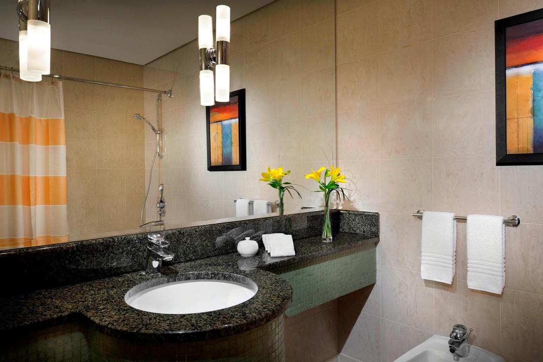 A spacious marble bathroom with contemporary fixtures, luxury bath amenities with full-size bathtub are featured in all guest rooms.