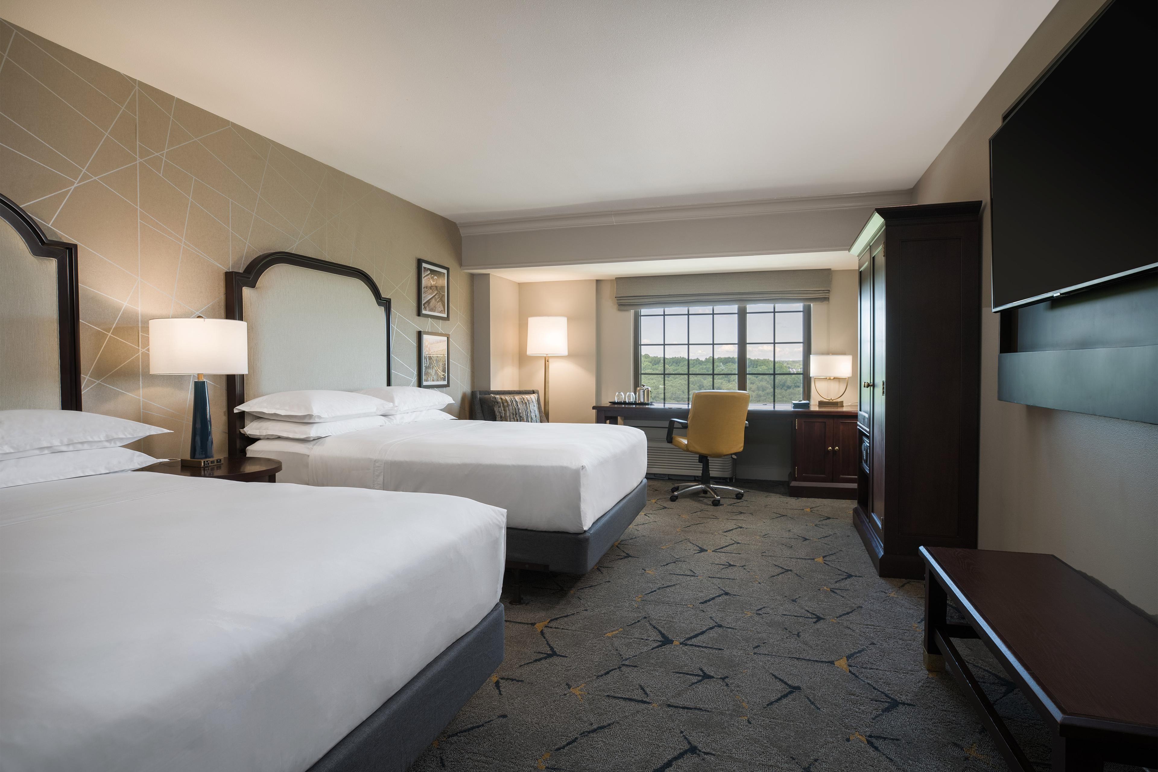Rest easy in our new double guest room with two queen-sized Sheraton Signature beds, ergonomic work desk and scenic views.