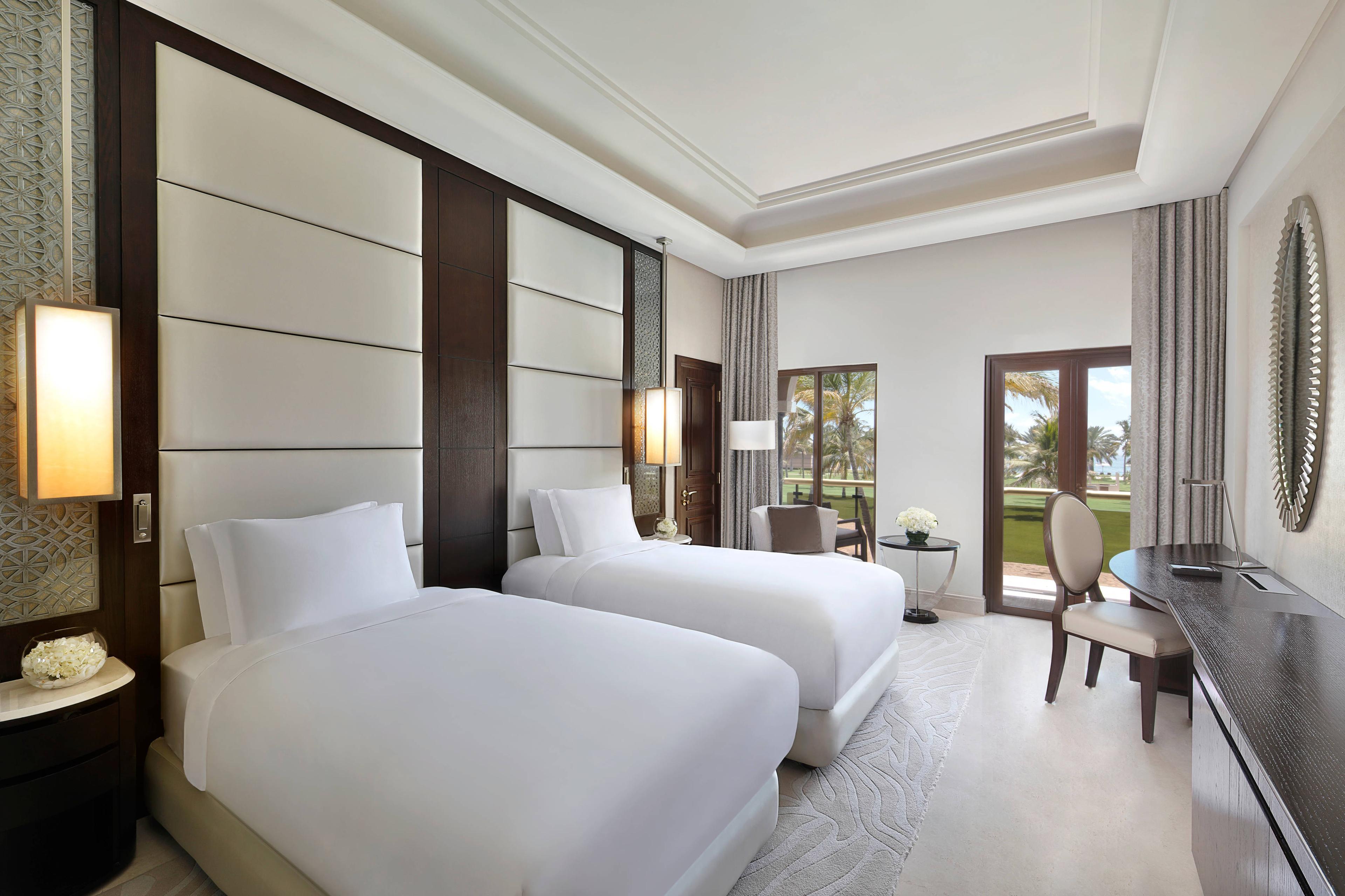 Deluxe Pool View Rooms offer views over the gardens, pools and the gulf of Oman on the horizon.