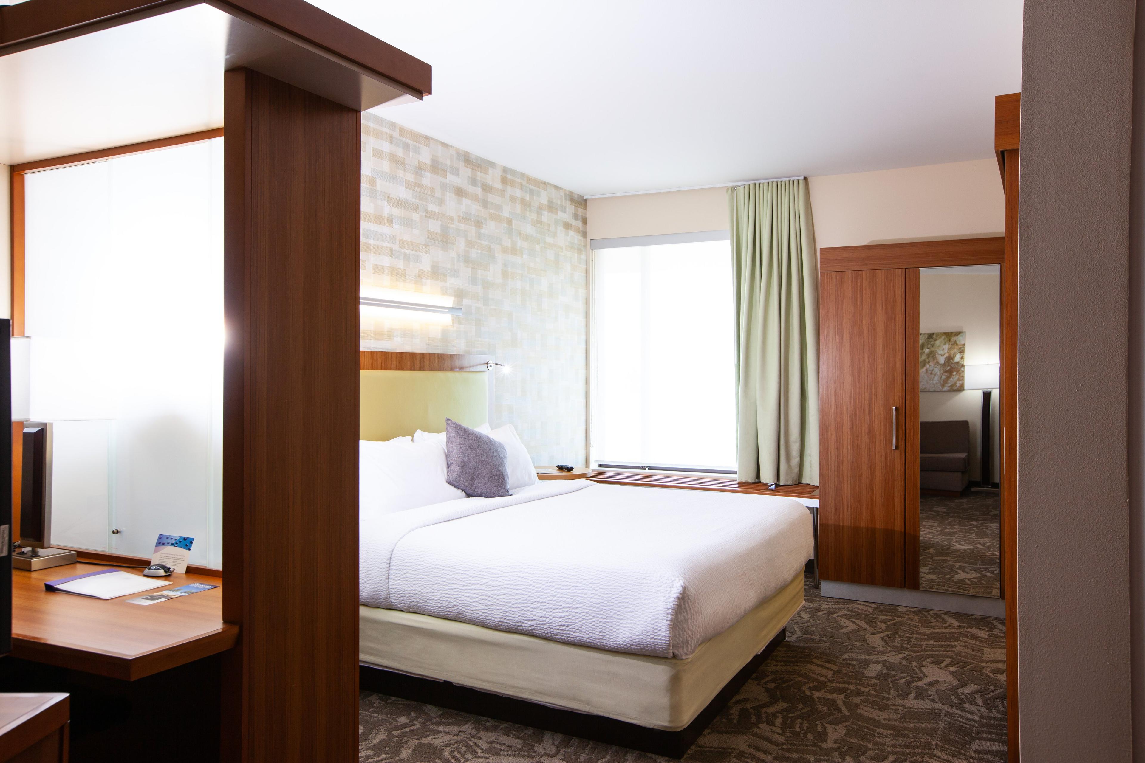 Our suites with a king-size bed feature separate living and sleeping areas and a spacious work desk.