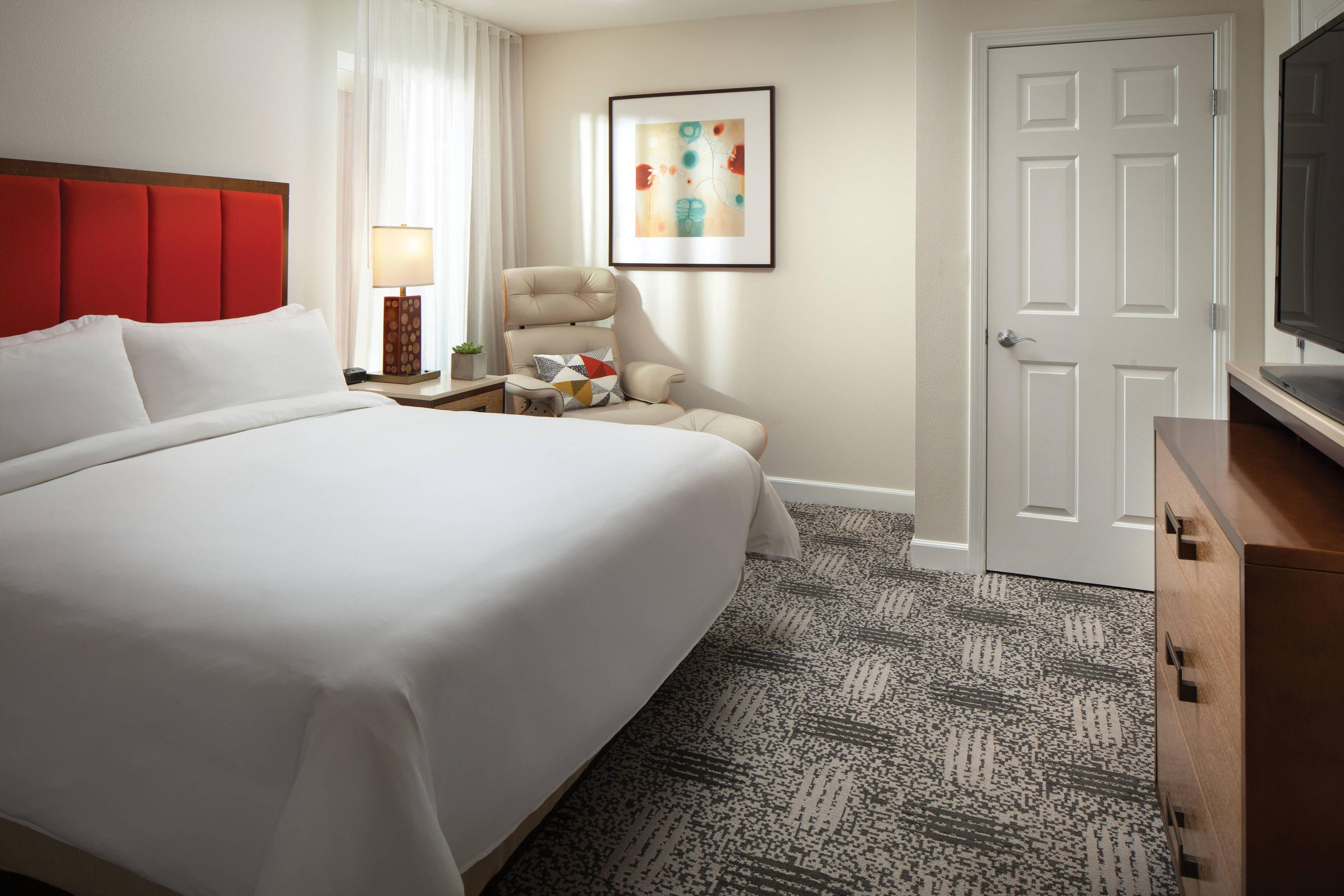 The comfortable master bedroom offers a king-size bed with plush bedding for a restful night's sleep.