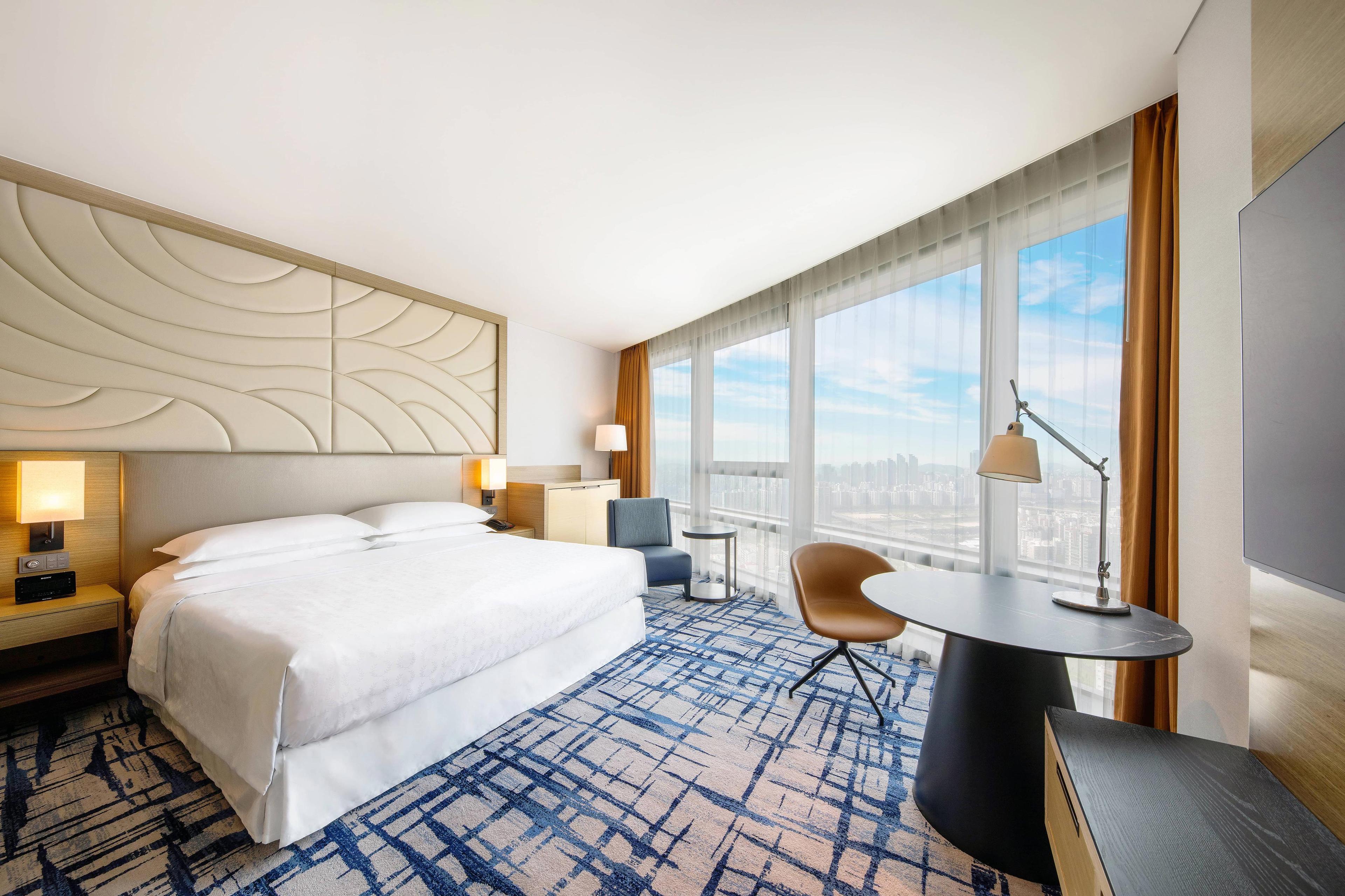 Stay relaxed at spacious guest room with a king-size bed, natural light, smart TV and outstanding view of Seoul.