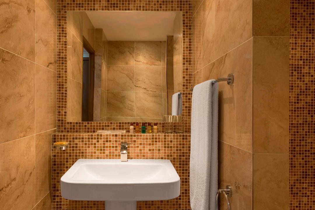 Our Standard bathrooms features a shower/tub combination, a robe and slippers for your convenience.
